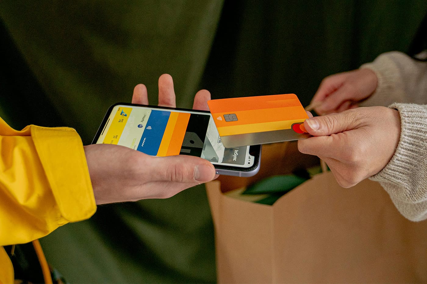 a person using they mobile phone to take a payment from a customer