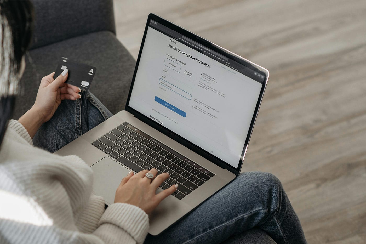 A person using a laptop paying for a service online using their payment card