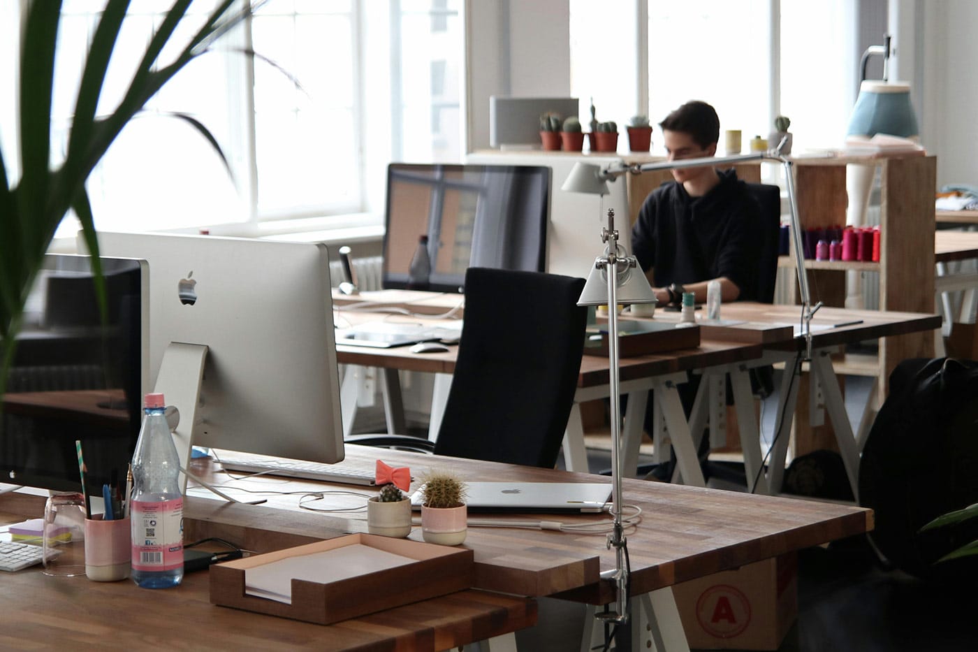 An office with a person working in the background