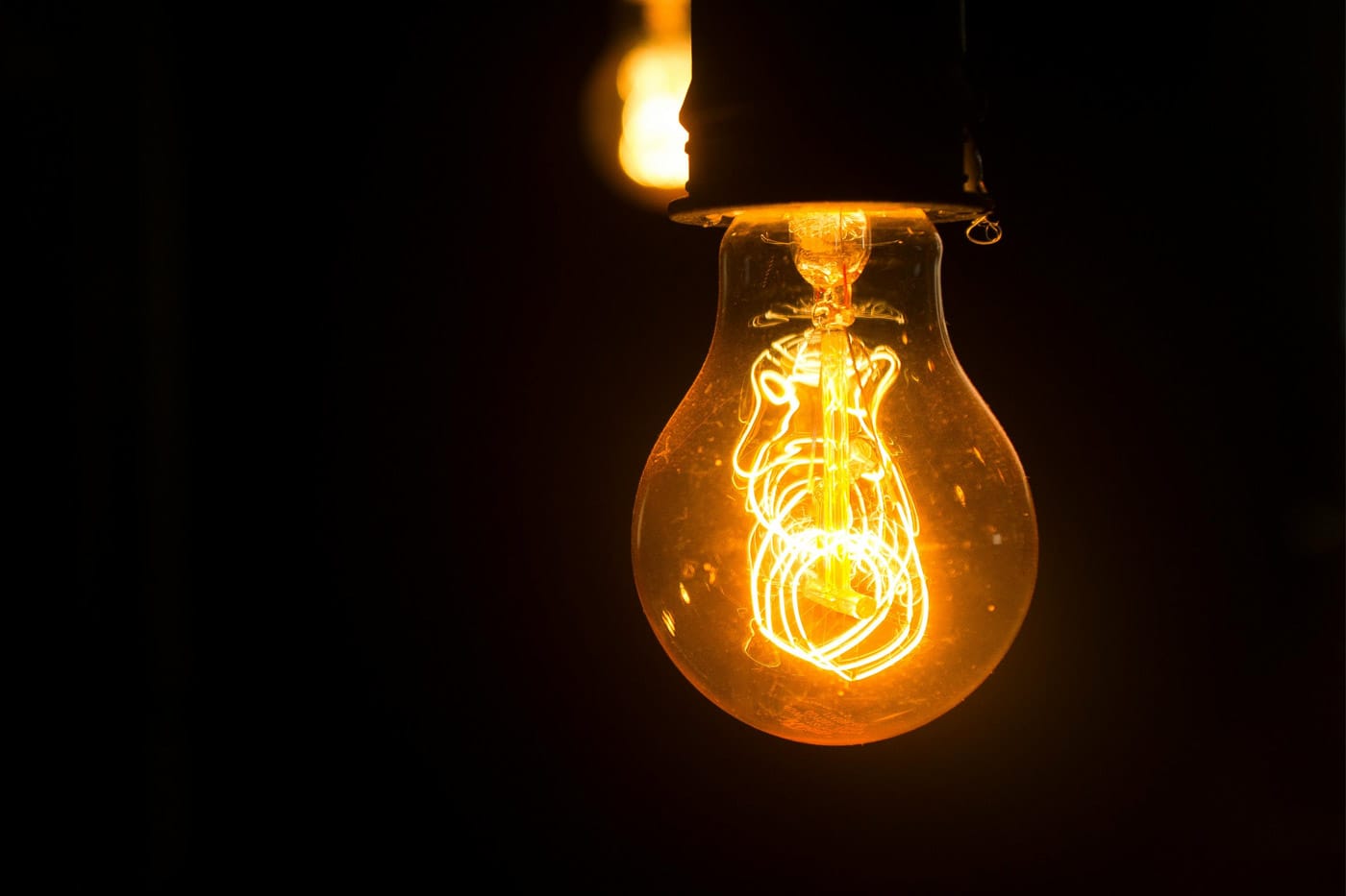 Lightbulb lit up with a dark background
